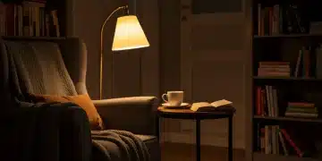 Cozy reading nook with armchair, warm lighting, and books