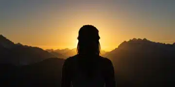 Master Your Mindset: Overcome Limiting Beliefs in 3 Months Woman overlooking sunrise, embodying a confident and new mindset