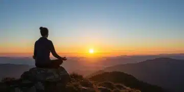Person meditating at sunrise, symbolizing peak energy and performance
