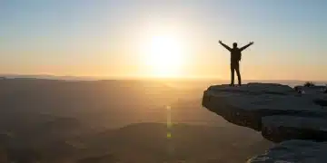 Confident person overlooking vast landscape, symbolizing unlocked potential