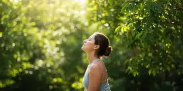 Person practicing mindful breathing in a peaceful natural setting